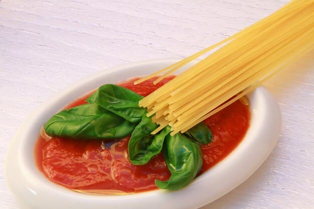 A close-up shot of a bowl of gluten-free spaghetti with a rich, homemade tomato sauce, garnished with fresh basil.
