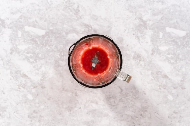 An overhead shot of a completed smoothie in a glass, next to a blender and individual ingredients (cut fruits, leafy greens, yogurt) in small bowls, all arranged on a clean white surface. The photo highlights the fresh and wholesome nature of the ingredients.