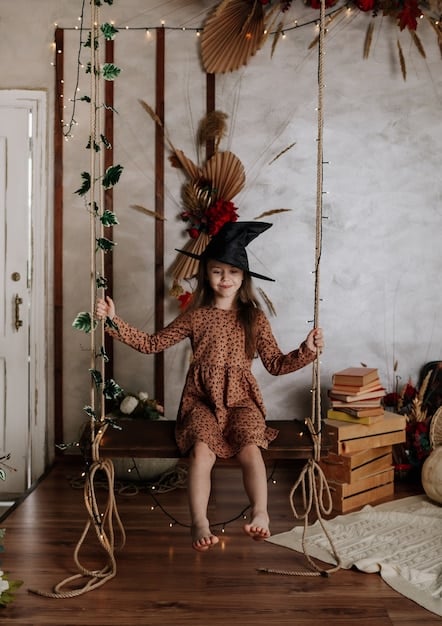 A living room transformed into an Indiana Jones themed setting with jungle vines, maps, and antique props. Children are dressed up as Indiana Jones, wearing fedoras and carrying toy whips.