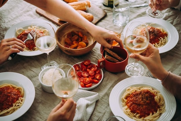 A close-knit family gathered around a dining table, enjoying a meal of spaghetti and meatballs. The scene captures the warmth and togetherness of a family sharing food, with laughter and conversation filling the air.
