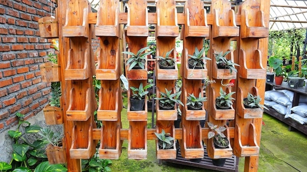 Close-up of various vertical garden structures, including stacked planters, wall-mounted pockets, and DIY wooden frames holding potted herbs. The image focuses on the textures and materials used to create the vertical effect, emphasizing the different design possibilities for small spaces.