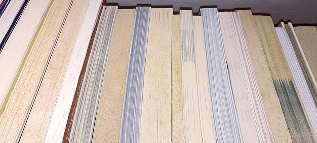 Close-up of various wood samples (pine, oak, maple) with different finishes, along with measuring tape and a notebook for planning a custom bookshelf project.