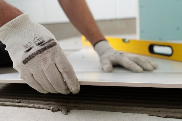 A close-up of a homeowner carefully using a tile saw to cut ceramic tiles for the bathroom renovation, with safety goggles and gloves visible.