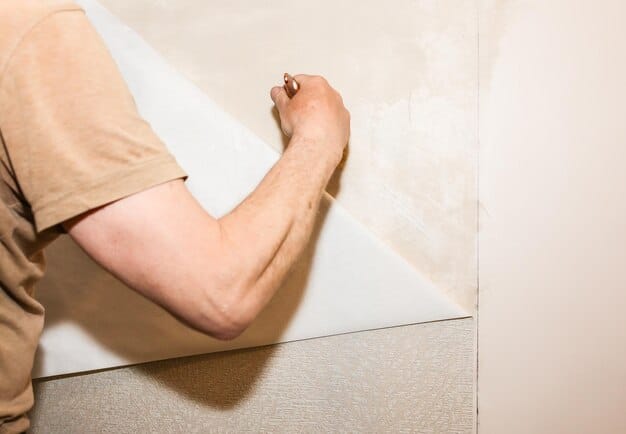A homeowner applying grout between newly laid ceramic tiles in the bathroom, using a grout float and sponge.