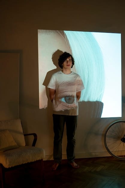 A person setting up a projector screen in their living room, adjusting the height and angle for optimal viewing. The room is dimly lit, highlighting the projected image on the screen.