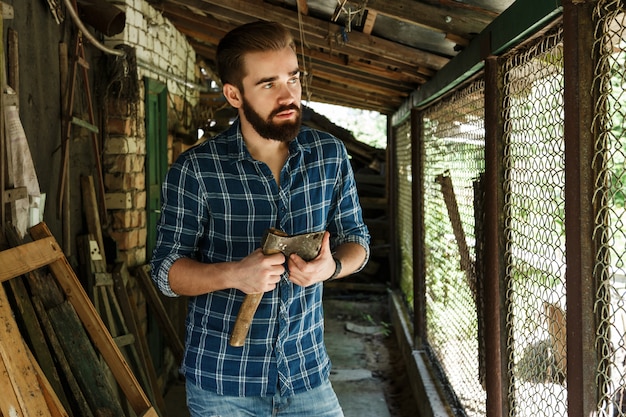 A close-up shot of a person building the frame of a chicken coop using wood and screws. The focus is on the hands and the tools, showing the process of constructing the frame.