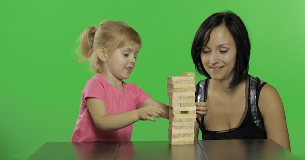 A child building a tower with blocks, with a parent helping guide them. Both are focused and engaged in the activity, showcasing supportive interaction and learning.