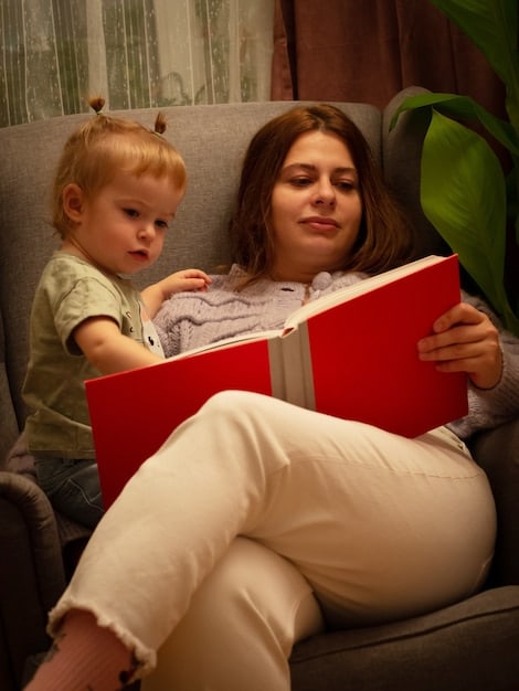 A close-up shot of a parent and child, the parent gesturing towards a picture book that they are reading together, both with engaged and happy expressions.