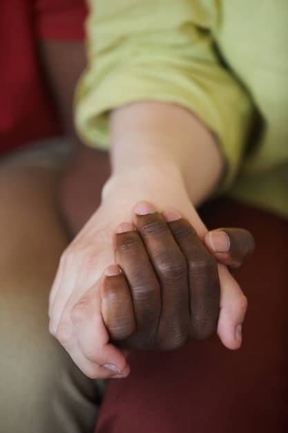 A close-up of a caregiver's hands clasped together, symbolizing the stress and emotional burden of caregiving. The background is blurred, focusing attention on the caregiver's hands and the weight they carry.