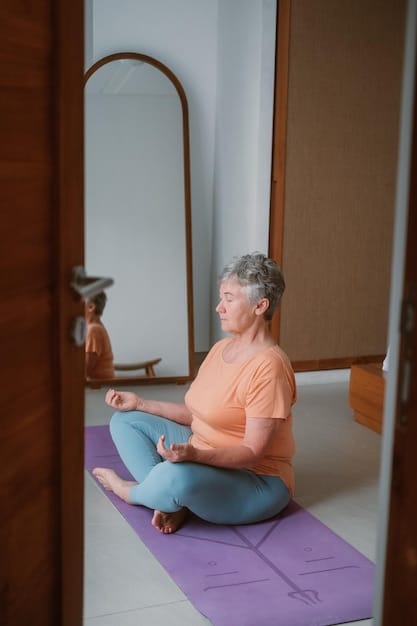 A caregiver smiling while practicing yoga in a serene living room, with soft lighting and a yoga mat, showing self-care through physical activity.