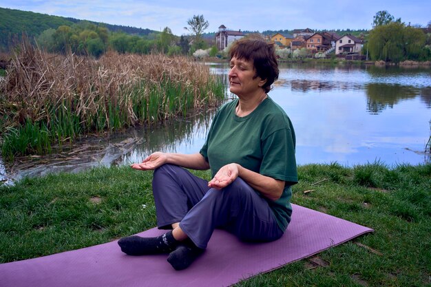 A caregiver meditating in a quiet garden, with eyes closed and hands resting on her knees, illustrating mindfulness and relaxation.