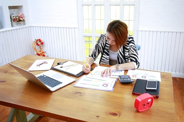 A person sitting at a desk reviewing tax documents with a calculator and pen nearby. The setting is a bright and organized home office, suggesting attention to detail and financial responsibility.