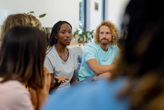 A group of diverse caregivers participating in a training session. The instructor is demonstrating a technique, and the caregivers are attentively watching and practicing. The setting is a bright and modern training room.
