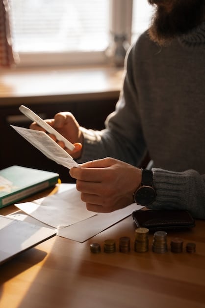 Close-up of a hand completing tax forms, with a calculator and pen nearby. Soft lighting and a focus on the paperwork emphasize the complexity of tax-related financial assistance.