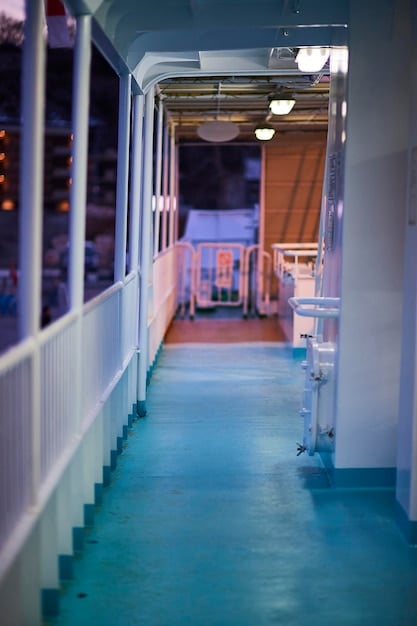 A clear, unobstructed hallway with bright lighting and grab bars installed along one side. The floor is free of rugs or clutter.