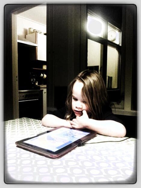 A split image showing a child happily using a tablet on one side, and the same child looking tired and grumpy the next morning on the other.