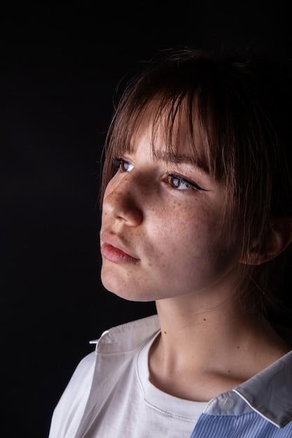 A close-up shot of a teen's face, showing a mixture of sadness and fatigue. The lighting is dim, and the background is blurred to focus on the teen's expression.