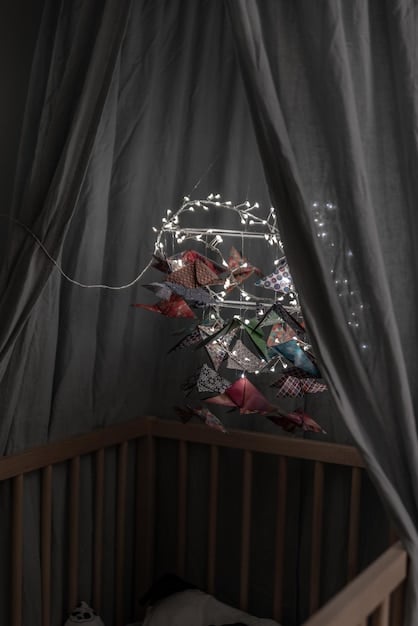 A dimly lit child's bedroom with blackout curtains, a white noise machine on a nightstand, and a comfortable bed. The room is tidy and free of clutter.
