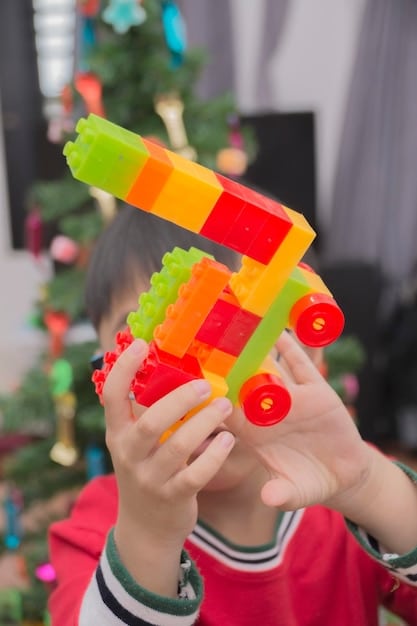 A close-up shot of a child's hands carefully constructing a tower with colorful building blocks. The blocks are arranged in a deliberate and focused manner, indicating the child's concentration and problem-solving skills.