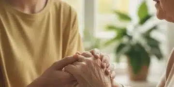 Close-up of a caregiver's hands gently holding an elderly person's hand, symbolizing comfort and support.